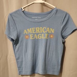 American Eagle Outfitters Light Blue Crop Tee with Yellow Daisy Logo